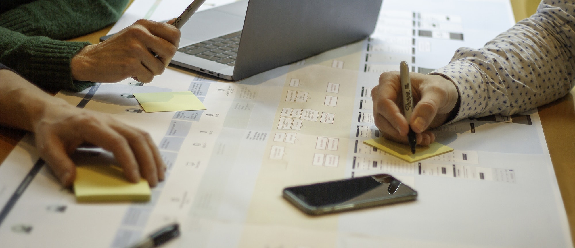 Mensen schrijven op sticky notes om een klantreis in kaart te brengen