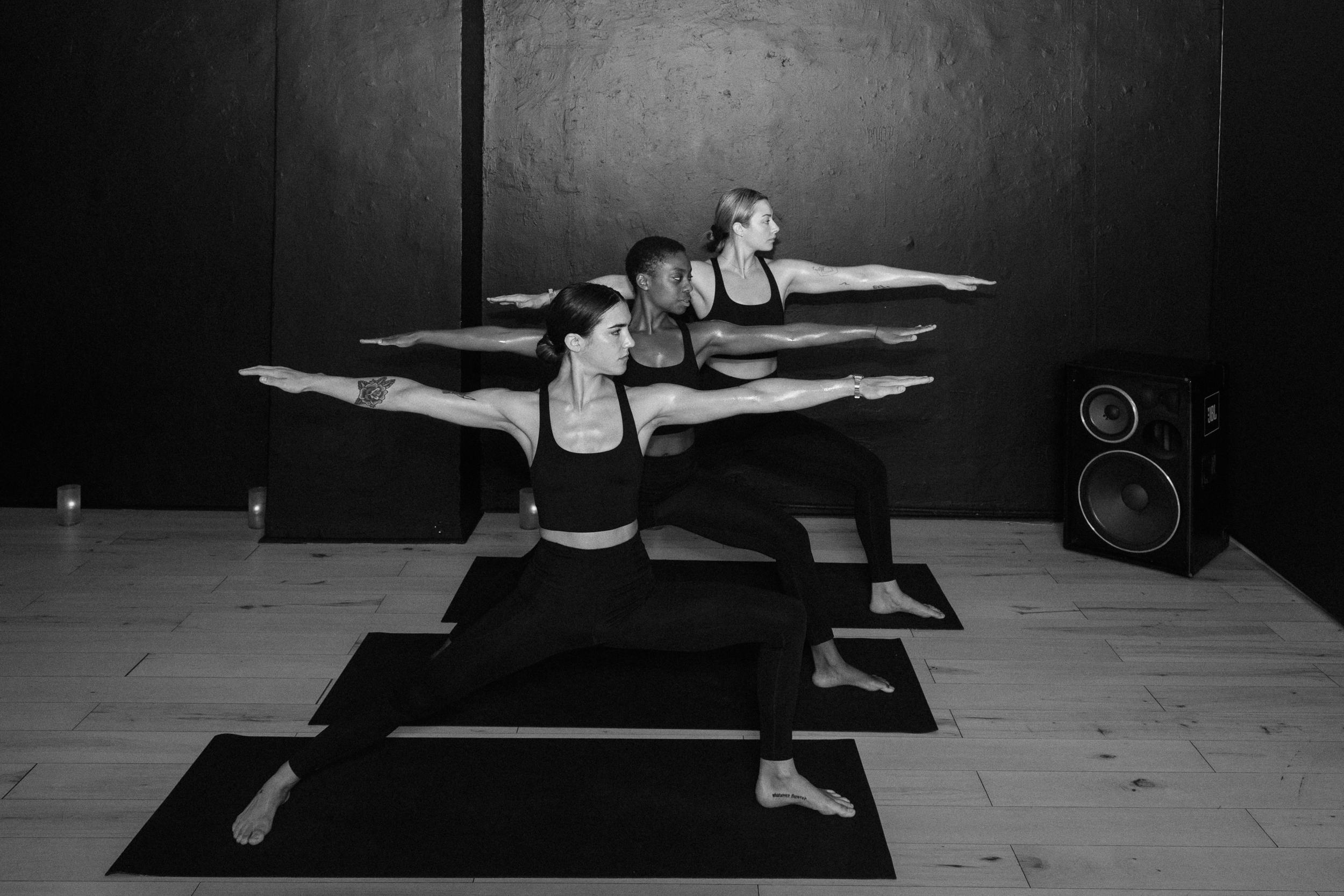 three women doing yoga