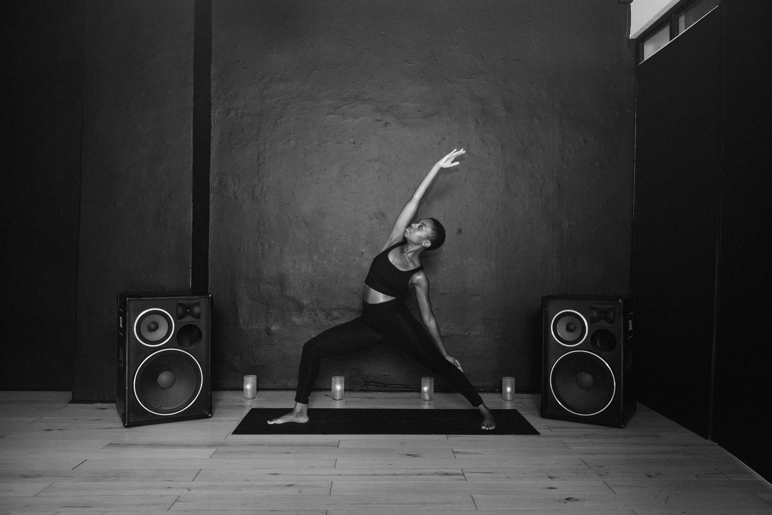 yoga pose in room with speakers