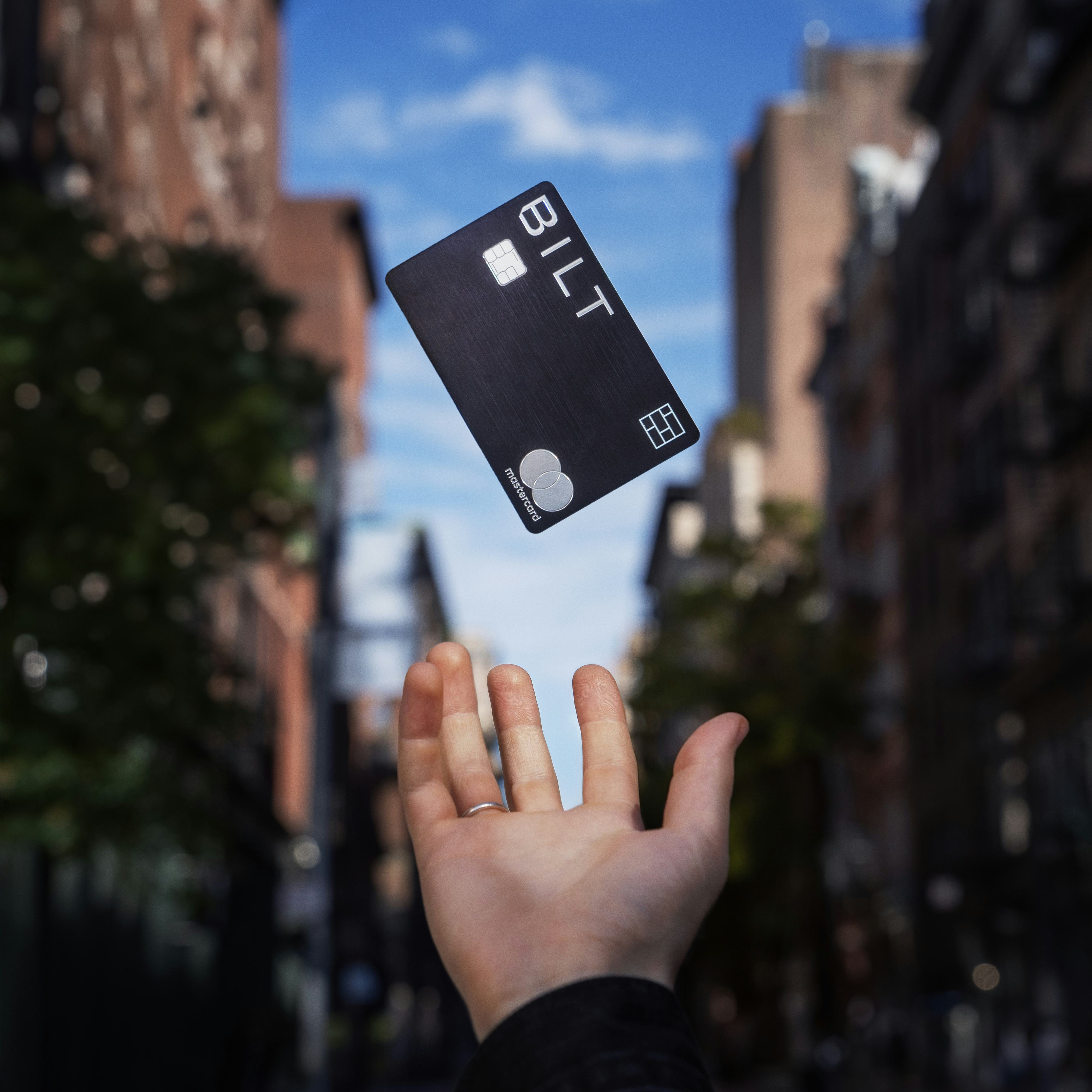 Bilt card floating against city background above outstretched hand