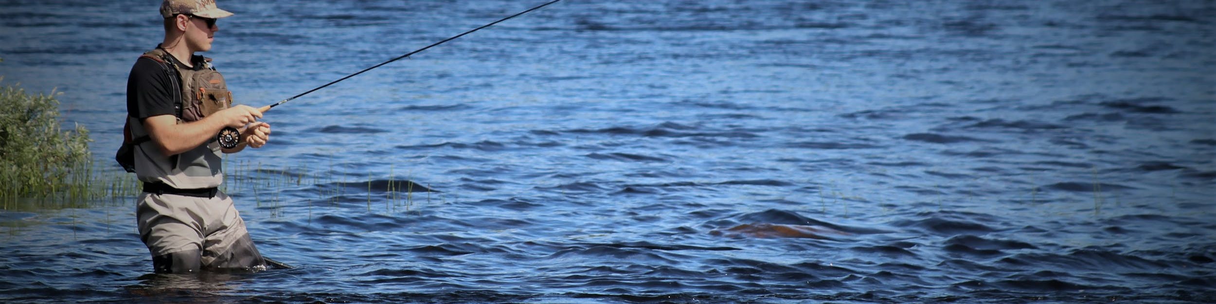 person fishing on river during daytime