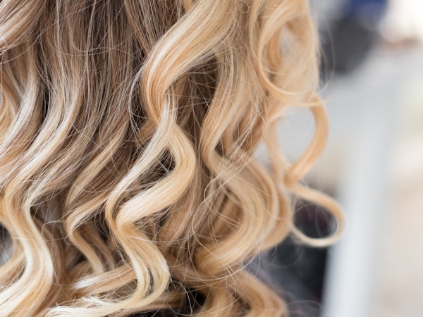 Lady with curly blonde highlighted hair