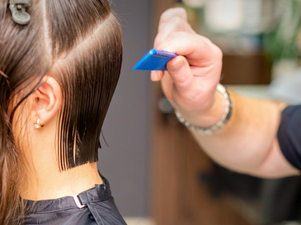 Mobile hairdresser cutting ladies hair
