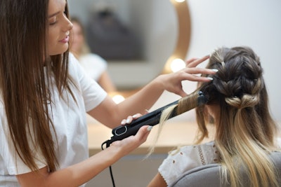 Woman getting her hair styled