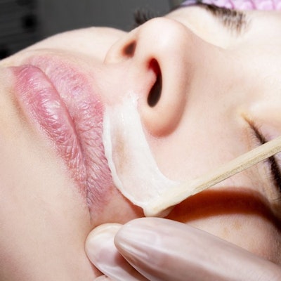 Woman receiving a lip wax