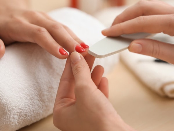 Woman receiving a manicure at home