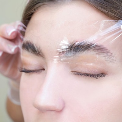 Woman receiving an Brow Lamination treatment