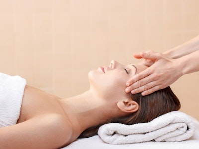 Woman at home receiving a luxurious spa facial treatment