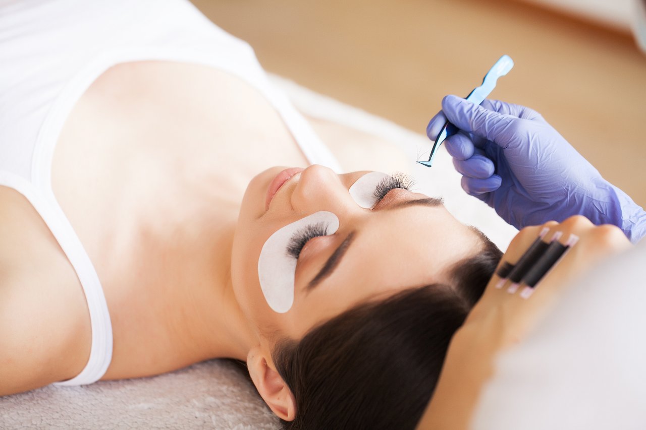 Woman having eyelash extensions