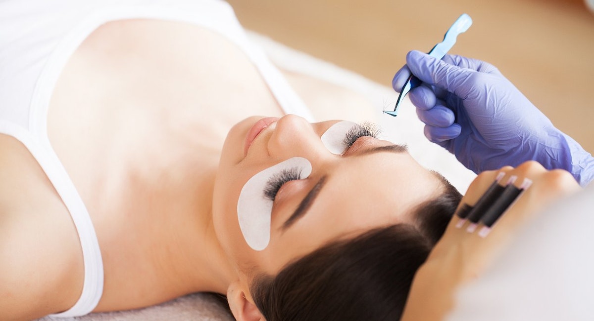 Woman having eyelash extensions