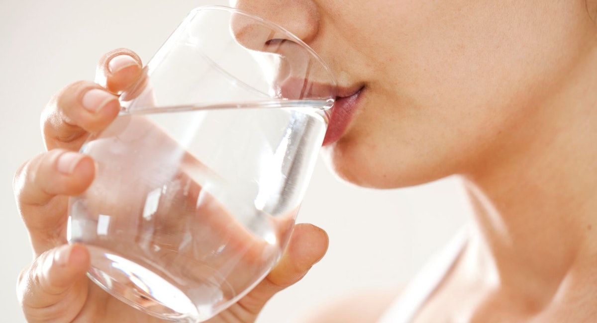 Woman drinking water after a massage
