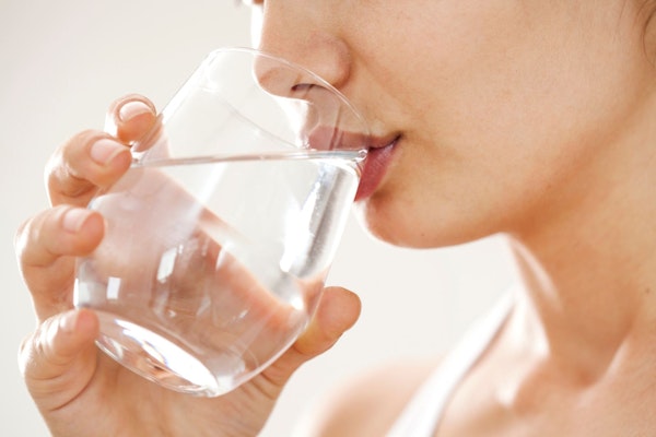 Woman drinking water after a massage