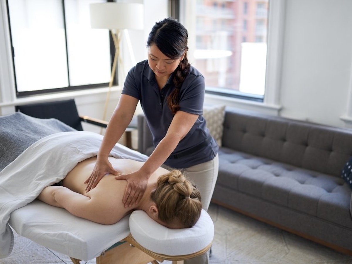 Woman receiving a relaxing massage treatment in her Edinburgh hotel room