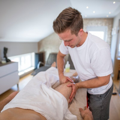 Man receiving therapeutic massage at home