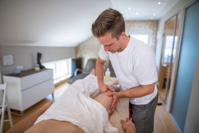 Man receiving therapeutic massage at home