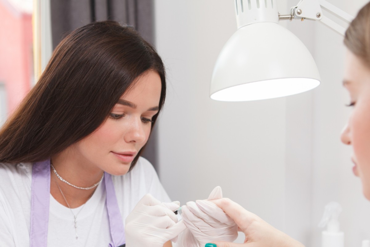 Mobile nail tech providing manicure in clients home
