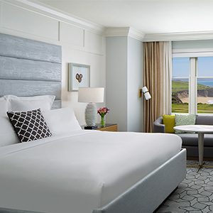 Ritz Carlton Hotel of spacious bedroom and the sight of ocean cliff outside the window