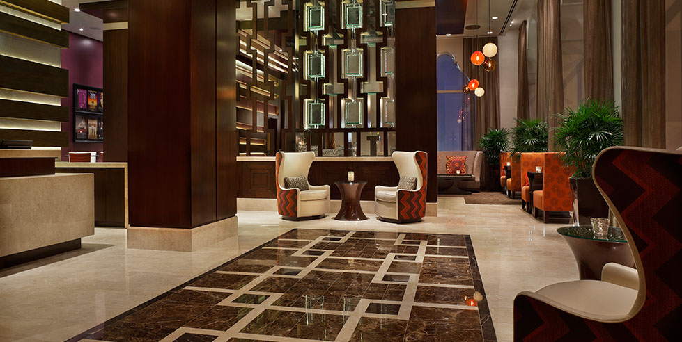 Adagio Hotel spacious lobby with warm lighting and mirror-like floors