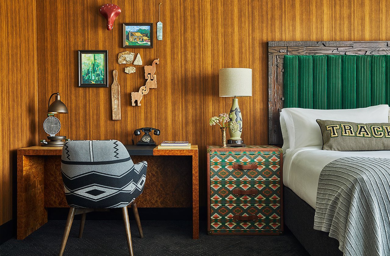 Tight shot of a stylish chair seated against a wooden desk with wooden wall behind