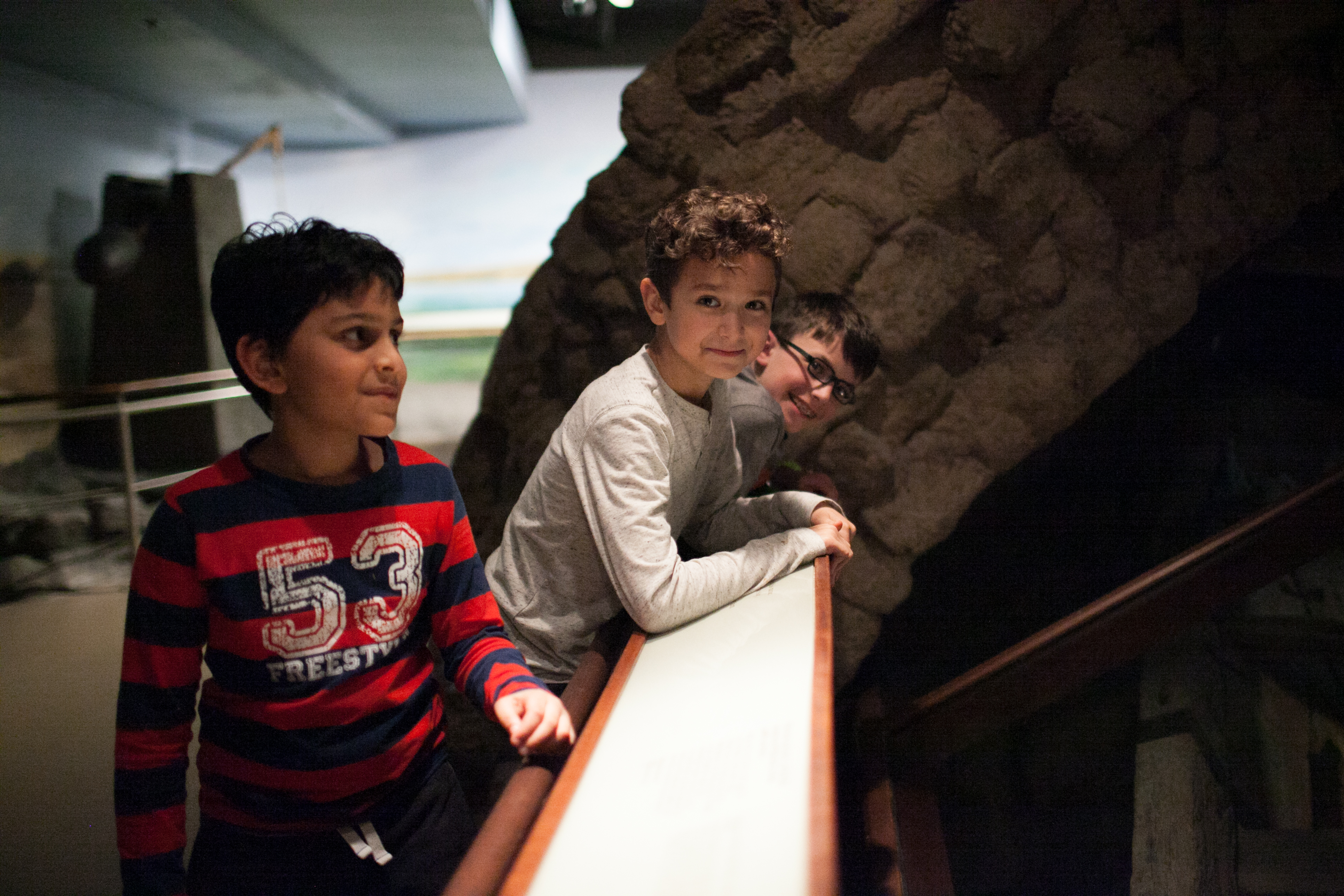 Three boys smiling in Ancient Egypt exhibition