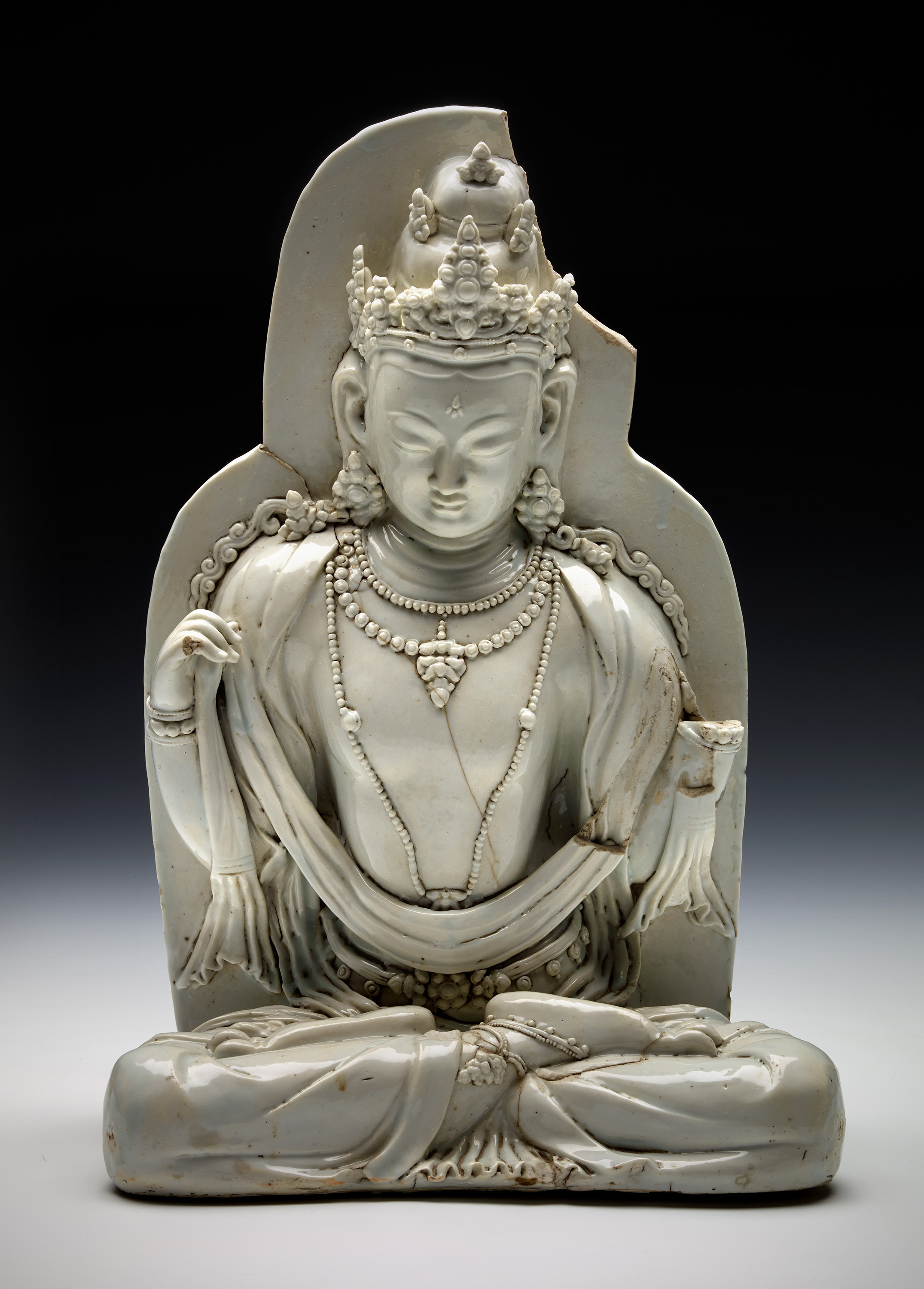 13.   Bodhisattva
The Buddha came to China accompanied by a host of attendants and bodhisattvas—enlightened beings who remain on earth to help humanity and attendants to the Buddha. This rare piece, depicting a seated bodhisattva, is made of porcelain and dates to the Yuan period (AD 1279–1368). 
© The Field Museum
