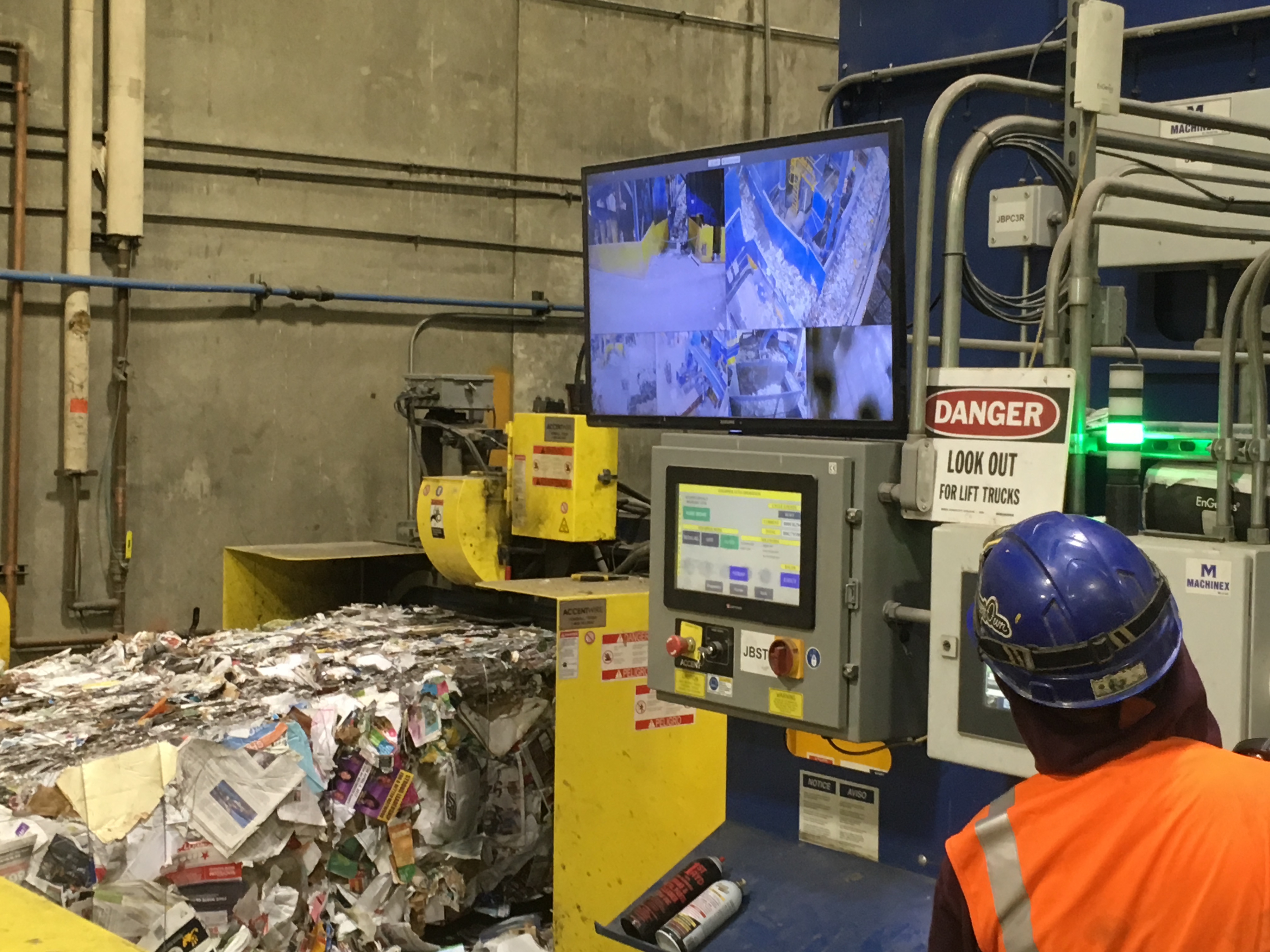 The Machinex Ram-II Baler, here calibrated for newspaper, pushes out a tightly bundled bale, ready for shipment to a manufacturer who will reuse this material.