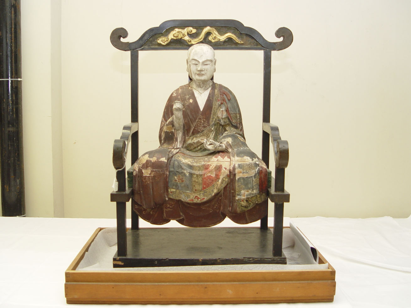This Japanese polychrome wood statue is dated to the mid c.18th CE.  The statue was assembled from multiple pieces of wood which were joined with wooden dowels.  The wood structure was then covered with a white gesso and the object was painted.  Cracks have opened in the statue and there has been at least one previous (undocumented) restoration attempt.