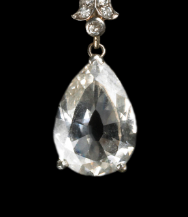 This large pear-shaped stone is a pendant on a necklace with colorless Diamonds set in Platinum. The shallow-cut 4-carat stone is a near-flawless colorless diamond measuring 11 mm in height.