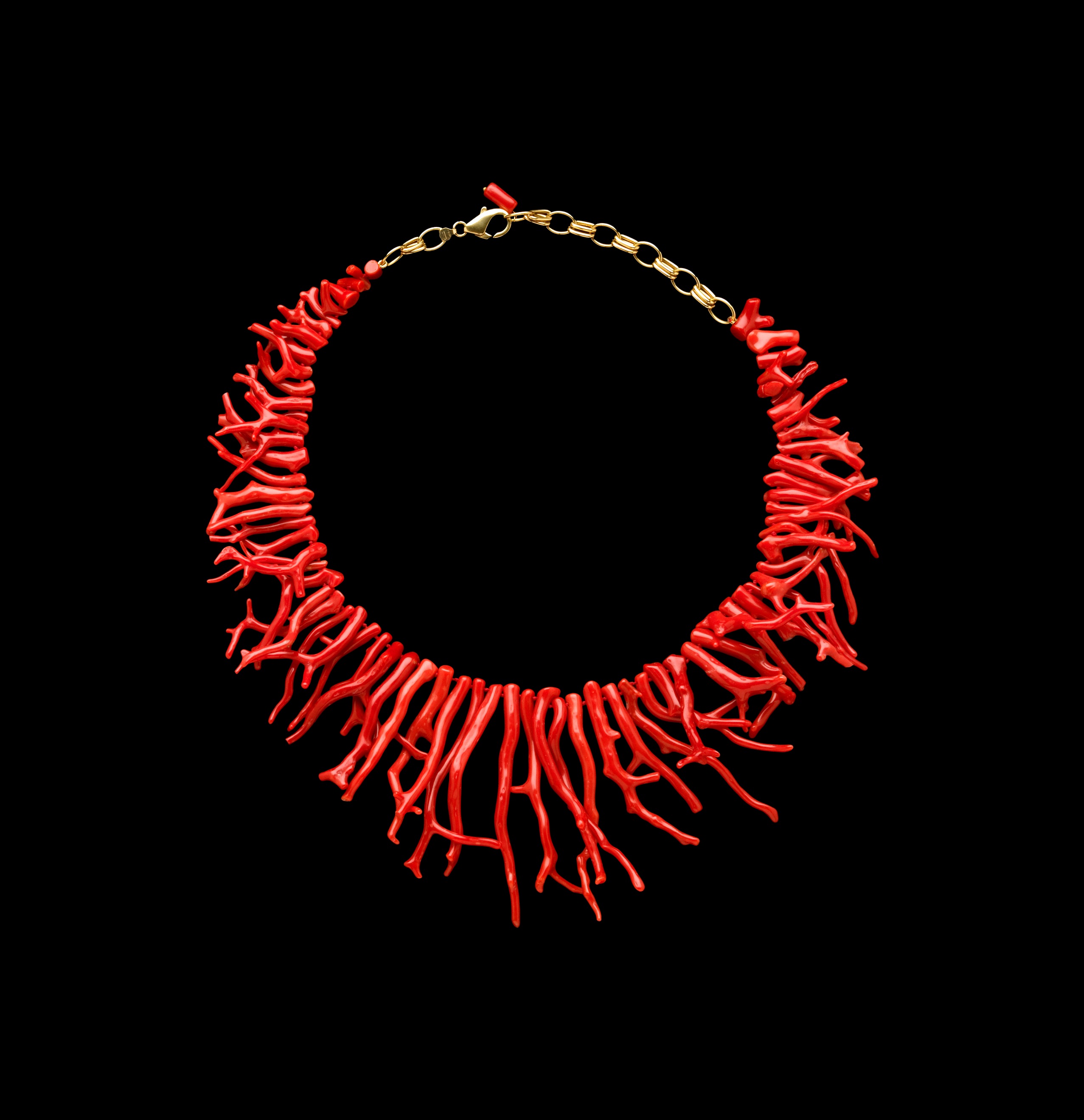 Rich red Coral necklace made of 74 small polished Coral branches.The coral branches gradually get longer as they move down from a gold clasp toward the center of the necklace.