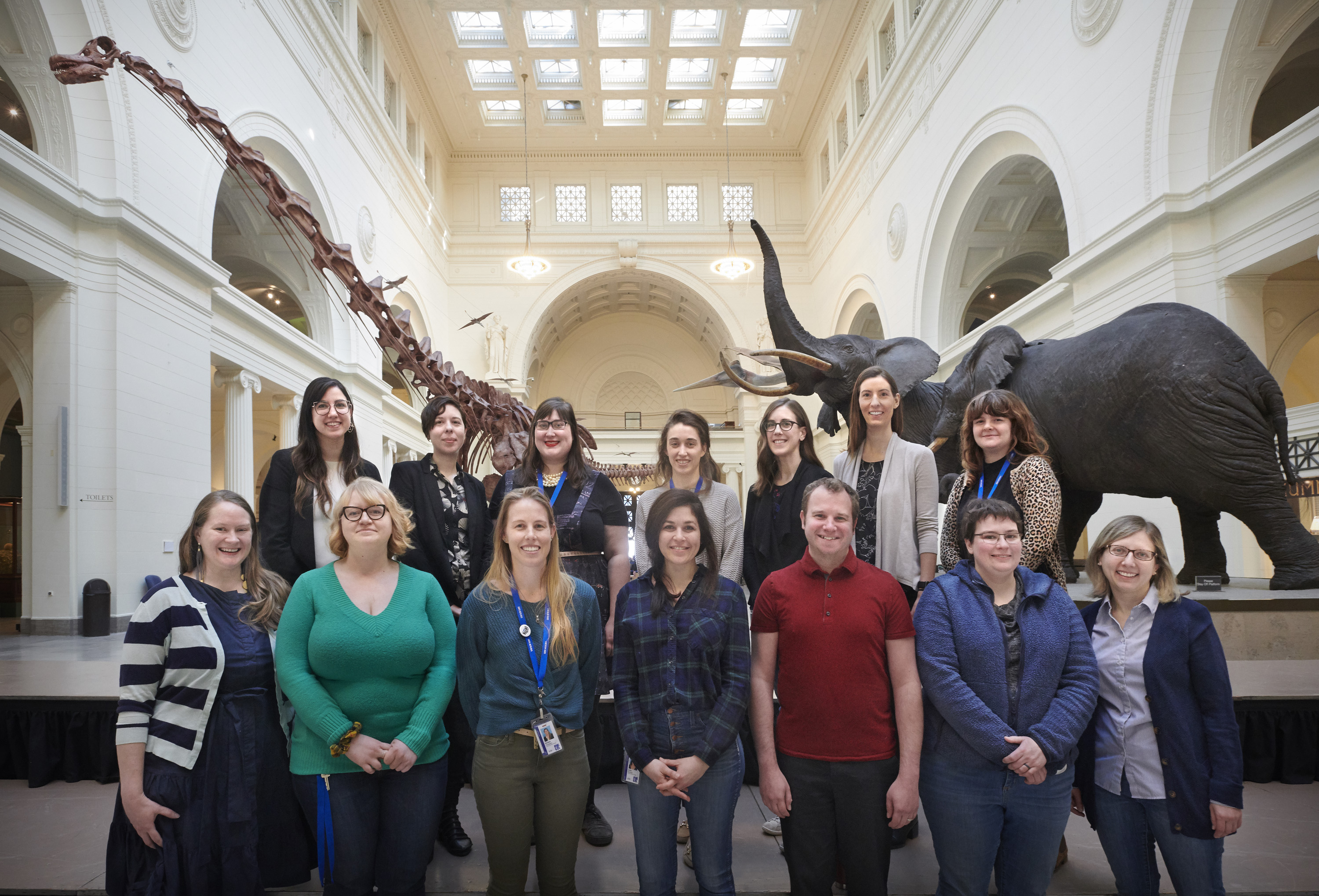 A group of museum employees standing in Stanley Field Hall