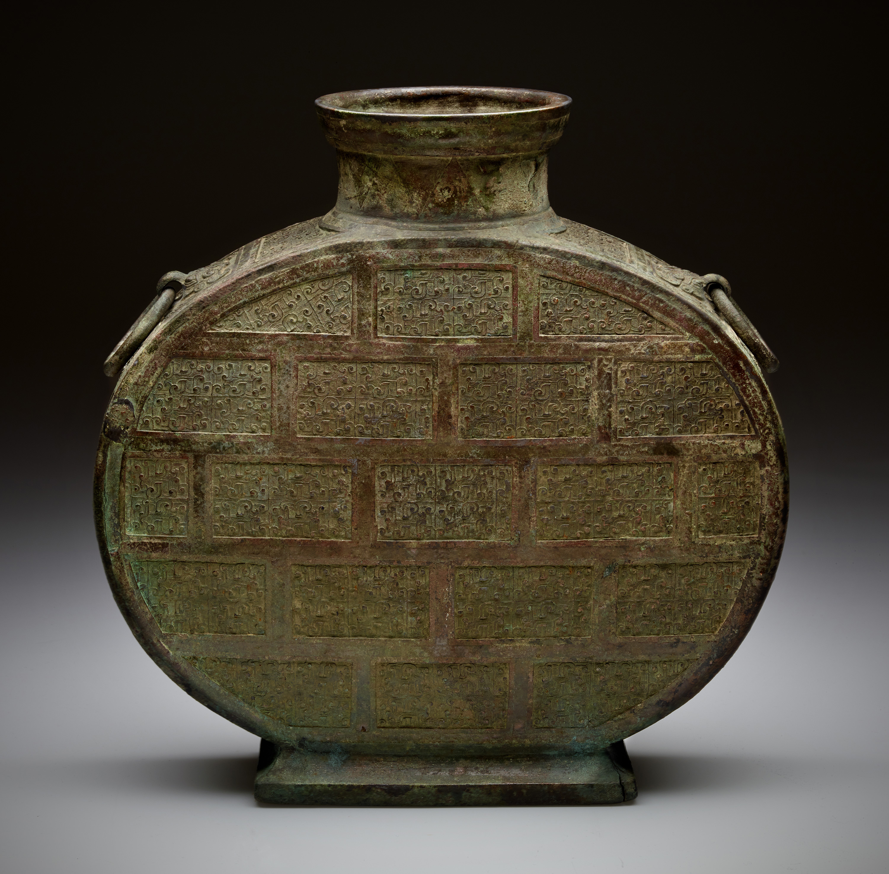 24.    Bronze Pilgrim Vessel
This bronze vessel—referred to in China as a bianhu (BEE-an-hoo) or “flat vessel”—dates to the Warring States period (475-221 BC).  It is a ritual vessel that once held wine, and it was eventually buried with its owner.  The flat-sided design of this vessel has been in continuous use for 2,000 years. Similar pieces can be found through the centuries in the Middle East, China, and England, made of pottery, bronze, and porcelain.
© The Field Museum