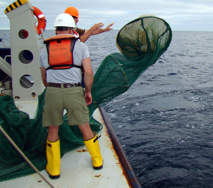 Kevin Swagel and the marine technician deploying the Issacs-Kidd midwater Trawl off the stern of the R/V Robert Gordon Sproul.