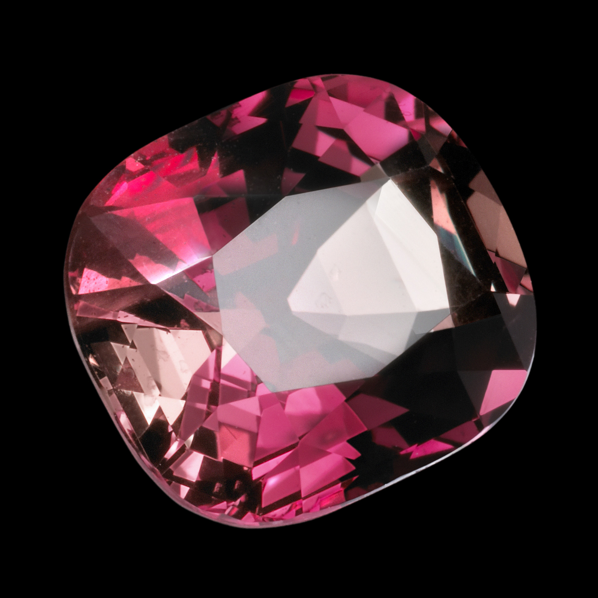 Faceted gem weighing 11.65 carats, a rare color changing variety of chrysoberyl called alexandrite. It is shown here in it's red color, as seen under incandescent light. The stone is 14 mm in height.