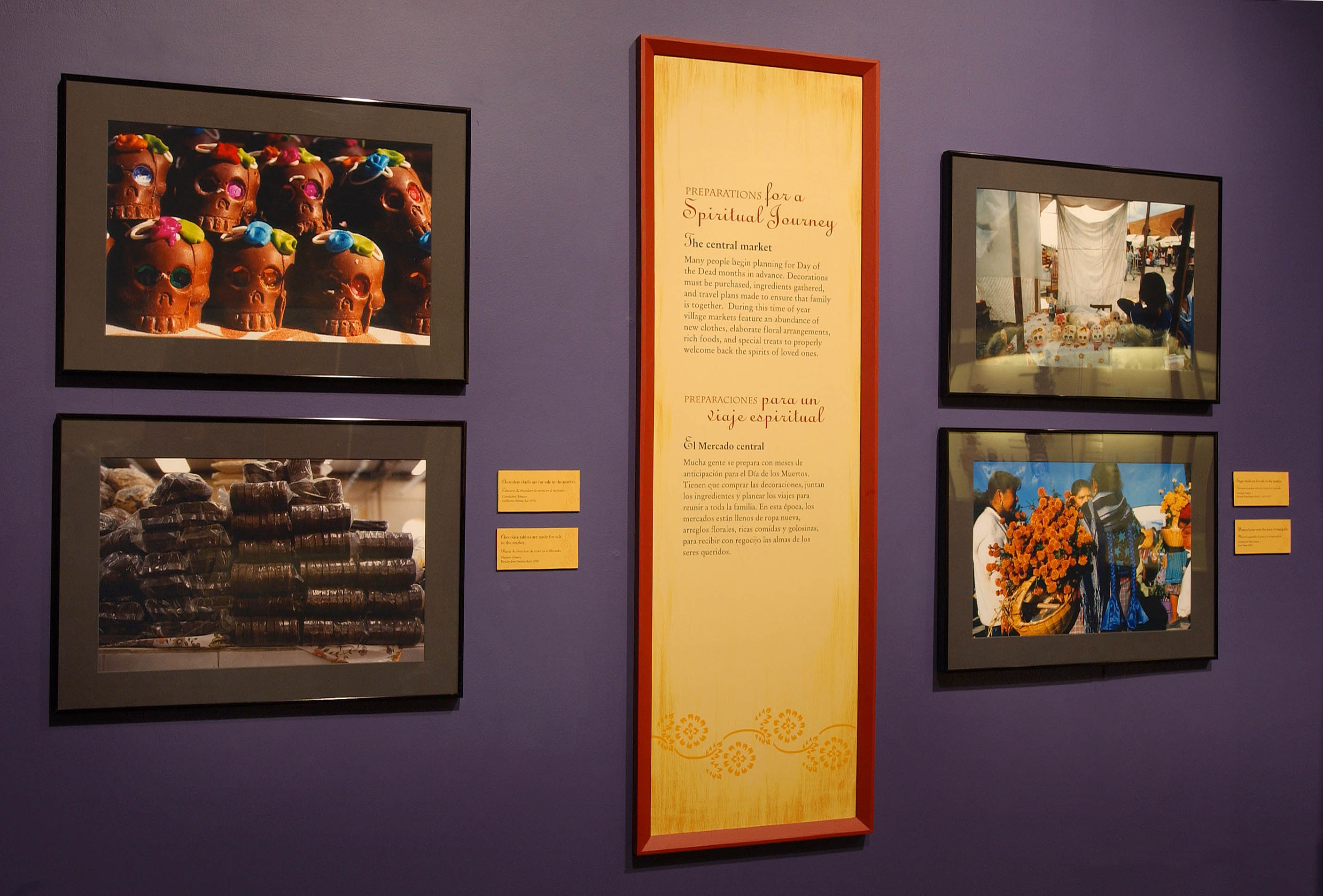 View of A Celebration of Souls exhibition, showing four photographs of different traditions practiced on Dia de los Muertos.