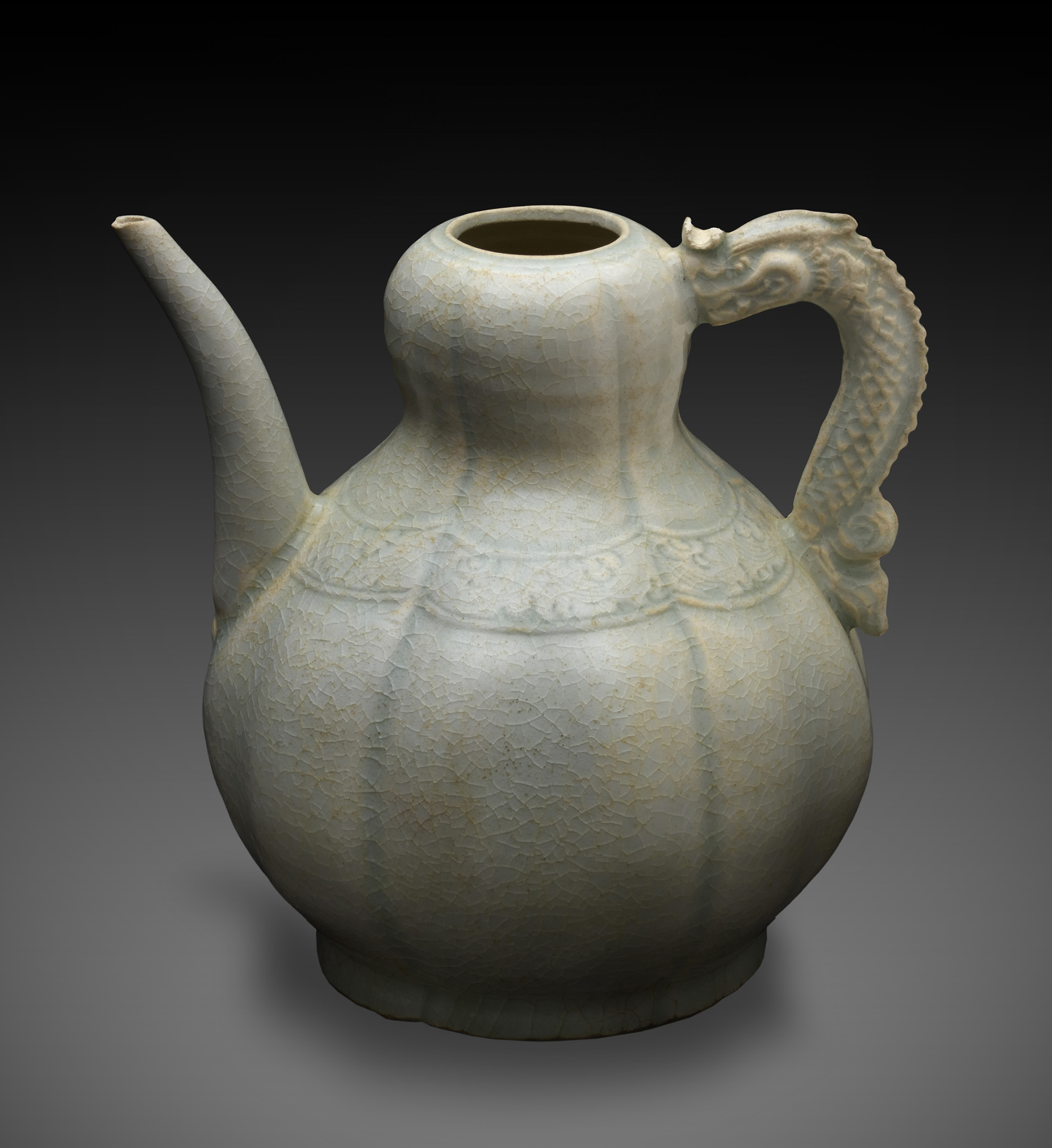 20.    Qingbai Ceramic Ewer
From the Java Sea Shipwreck
This ewer is covered in a translucent light blue glaze called qingbai (CHING-bye). Shaped like a gourd, this ewer may have offered healing or protection against disease or symbolized fertility. Its handle is shaped like a dragon, a mythical beast that could bring blessings.
© The Field Museum