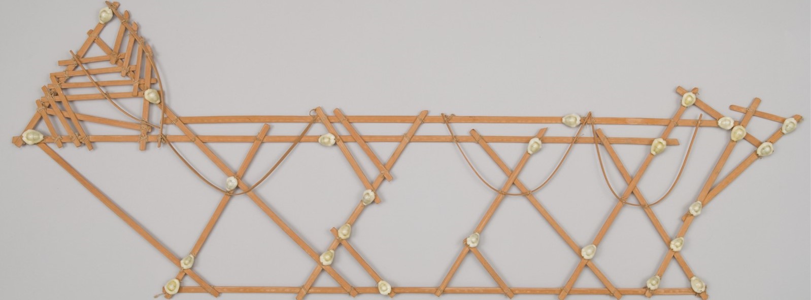 Micronesian navigation chart made from bamboo strips, cowrie shells, and fiber string from Majuro, Marshall Islands and collected by Marvin Montel-Cohen.  Catalog Number 3346.268405. © The Field Museum, A3513_268405_ATFront.