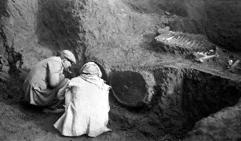 Henry Field (left) and workman looking at an exposed wheeled chariot.  Circa 1928, when the chariot was excavated, these were the first wheels found anywhere. Kish, Iraq.
 
© 1928 The Field Museum. ID# CSA59632