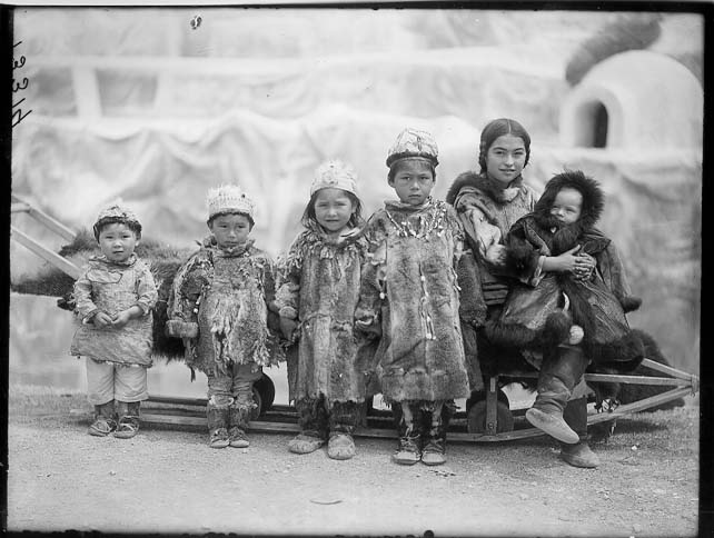 Several children, including Nancy Columbia, in the Eskimo exhibit at the Louisiana Purchase Exposition, St. Louis, 1904. 
Credit Information: © The Field MuseumID# CSA13314Photographer: Charles Carpenter
