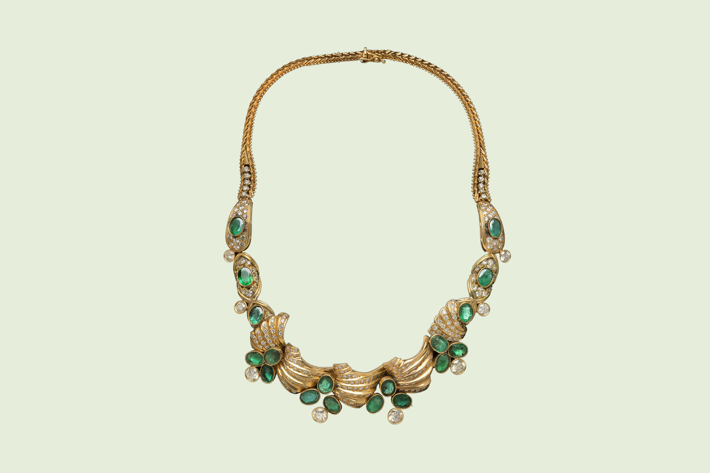Gold necklace, featuring diamonds and emeralds. 