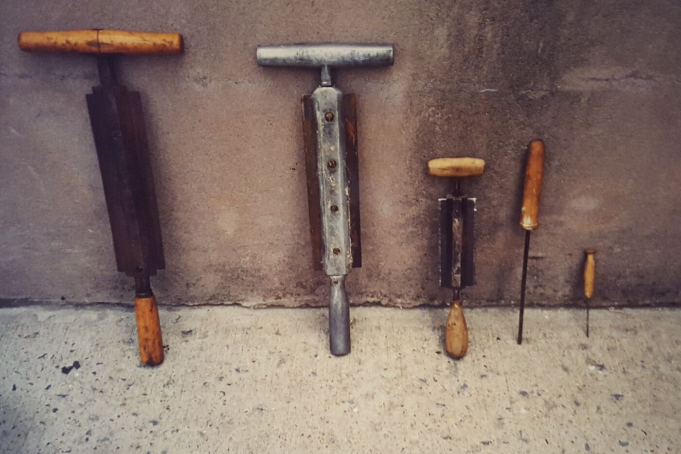 A series of tanning tools, lined up against a wall. 
