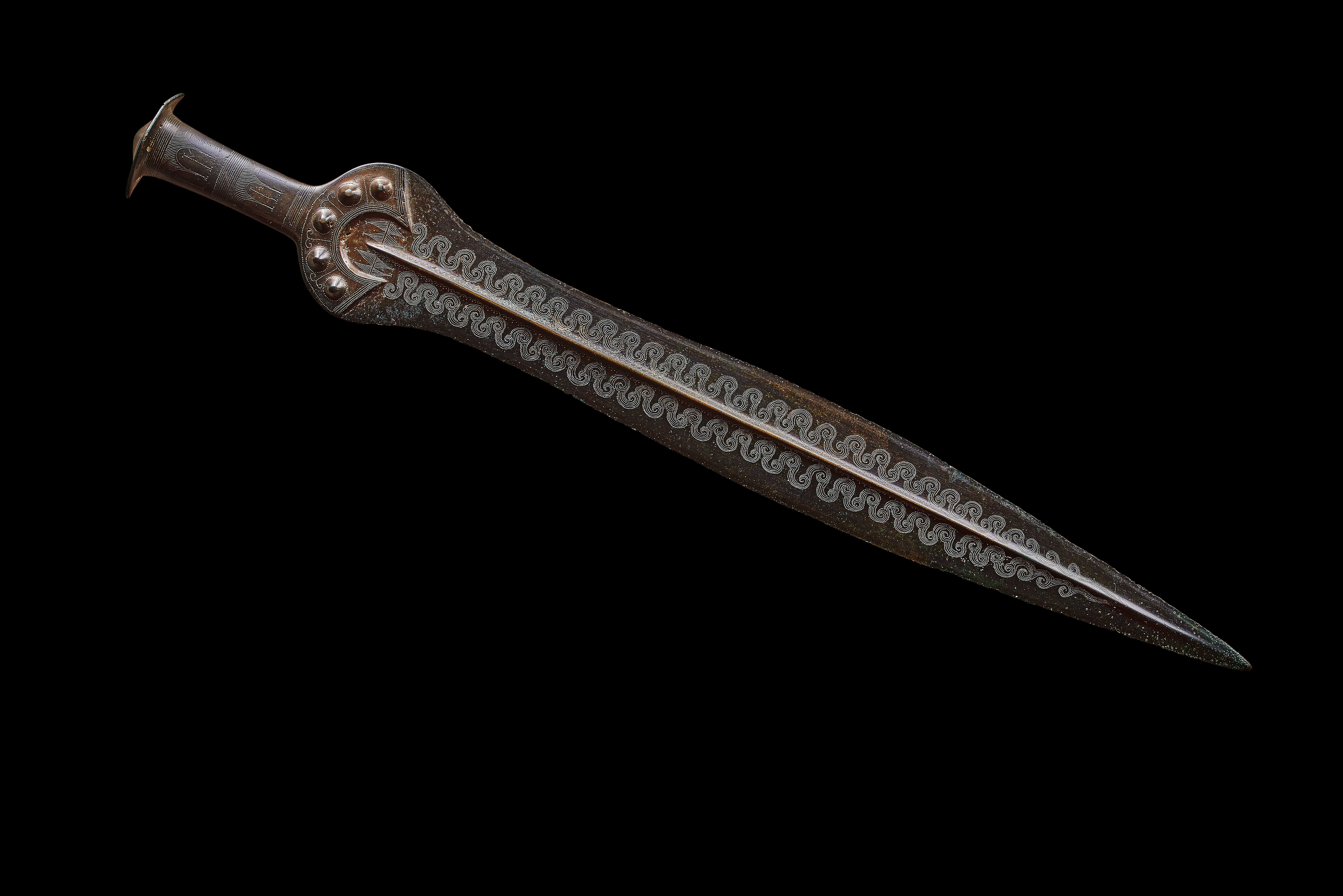 A bronze sword, with an etched serpentine pattern.