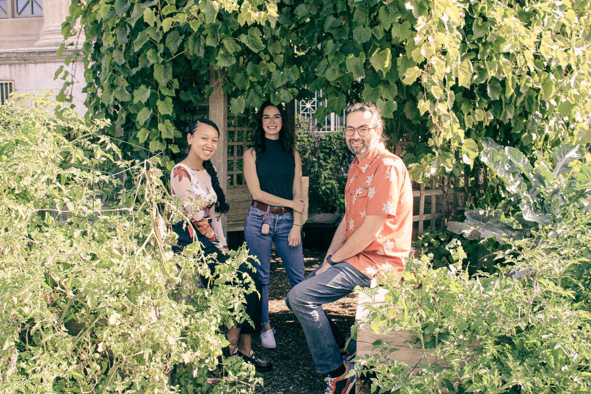 Three people sitting outside in the Museums garden.