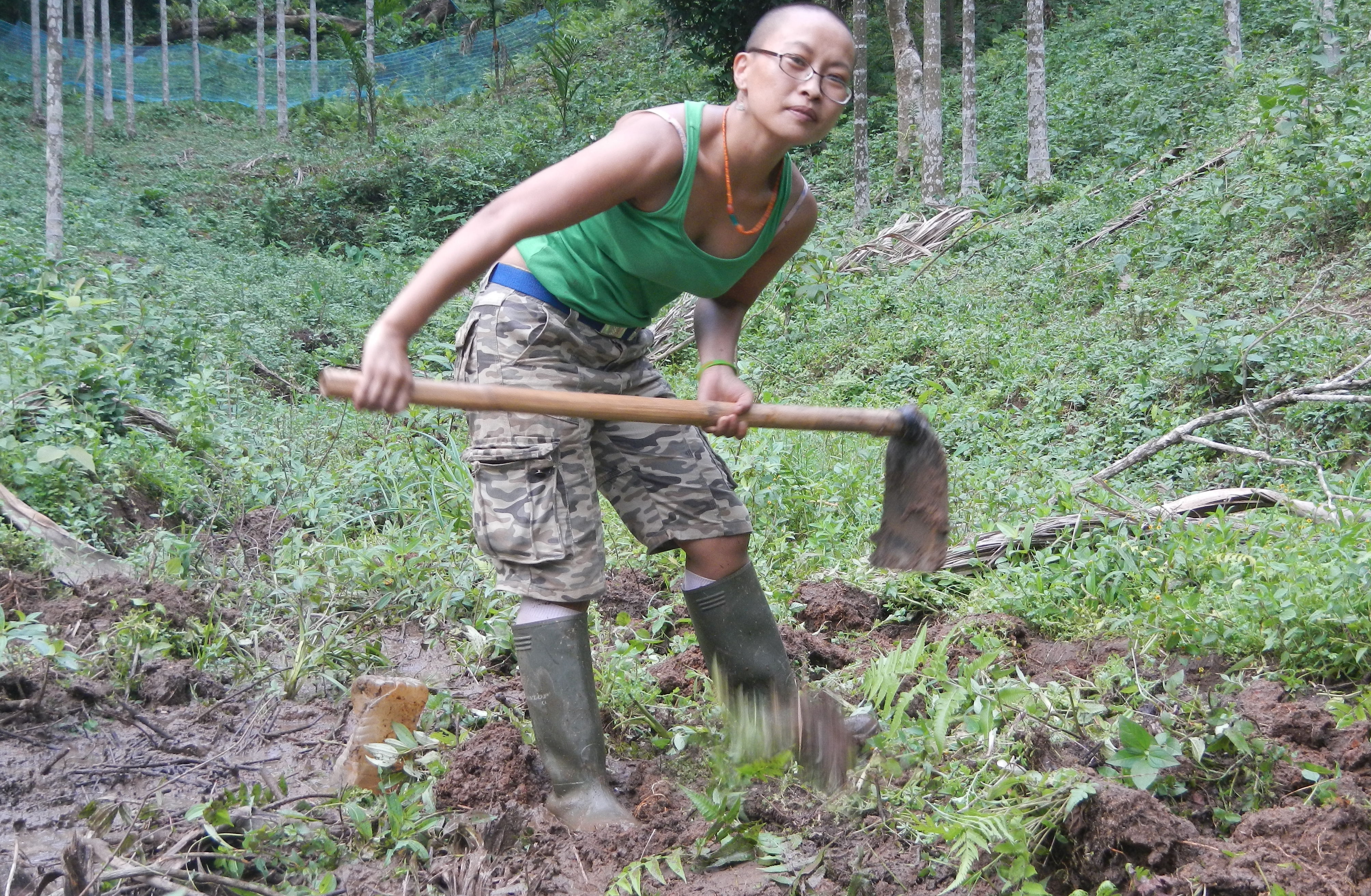 Chun Kamei holding a garden hoe