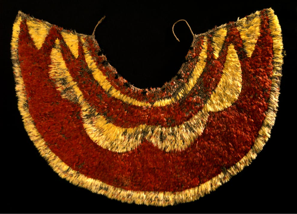 A large, wide cape made of red and yellow feathers.