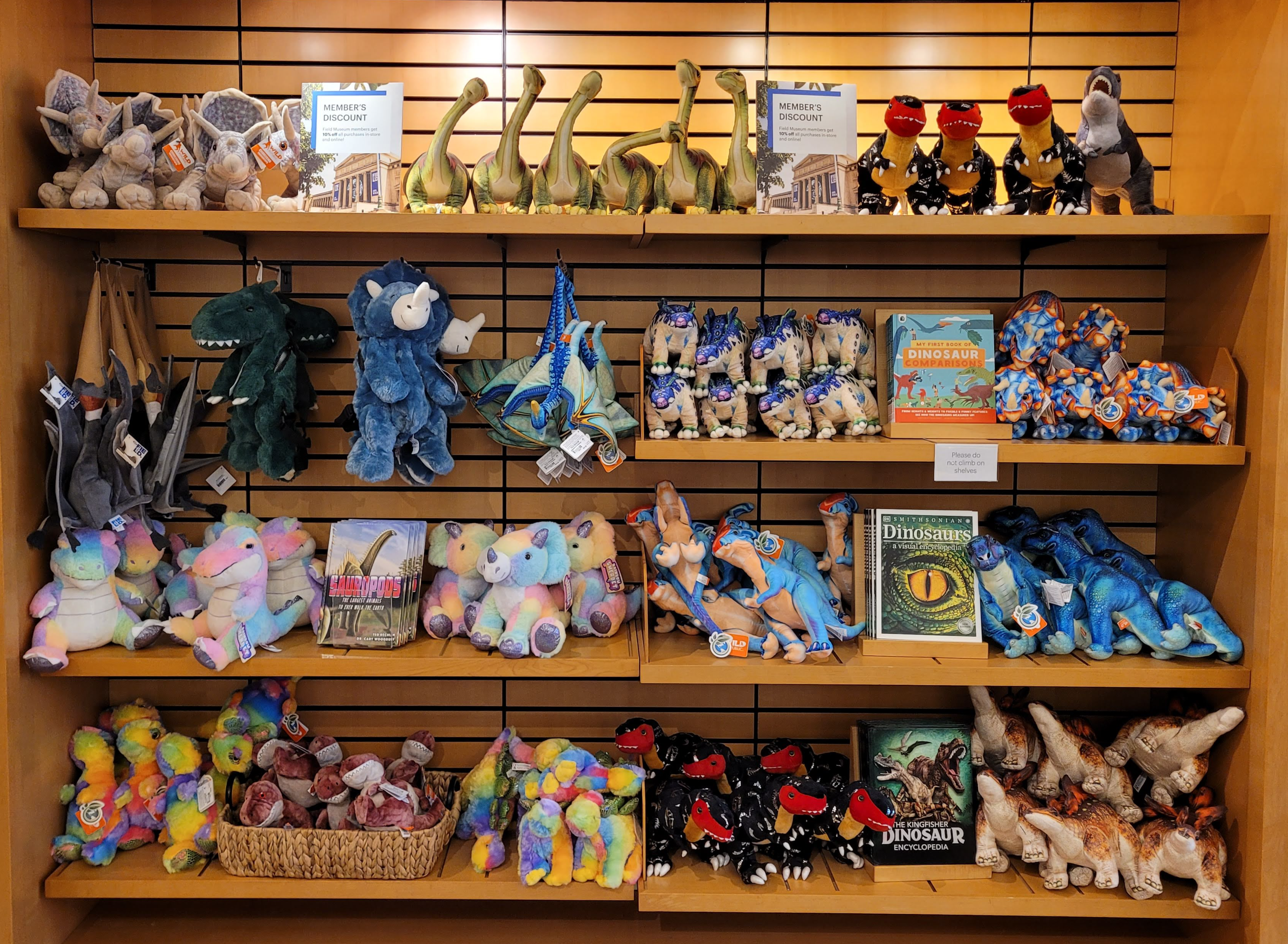 Shelves in the museum shop displaying plush dinosaur toys and books