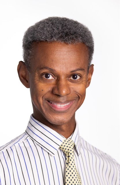 Headshot of a person wearing a shirt and tie