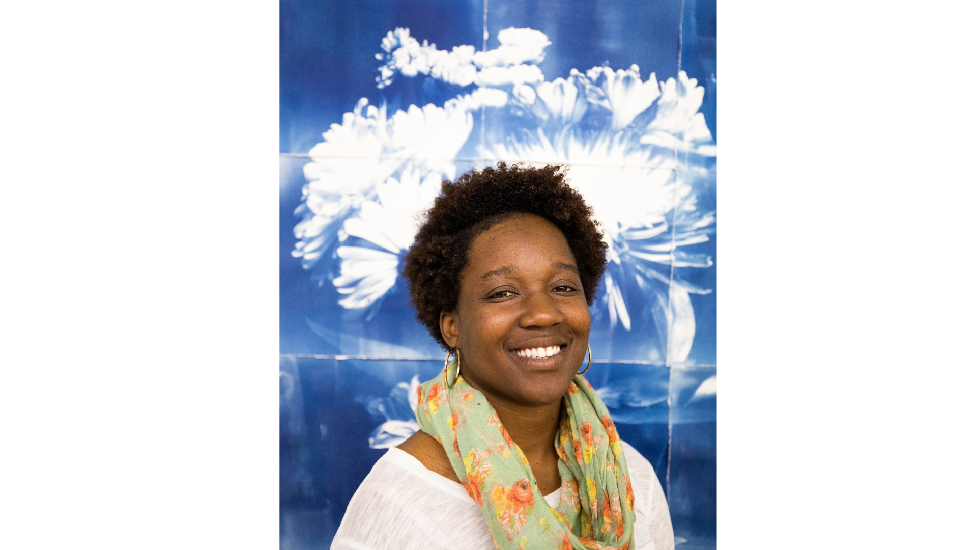A woman in front of a blue and white background