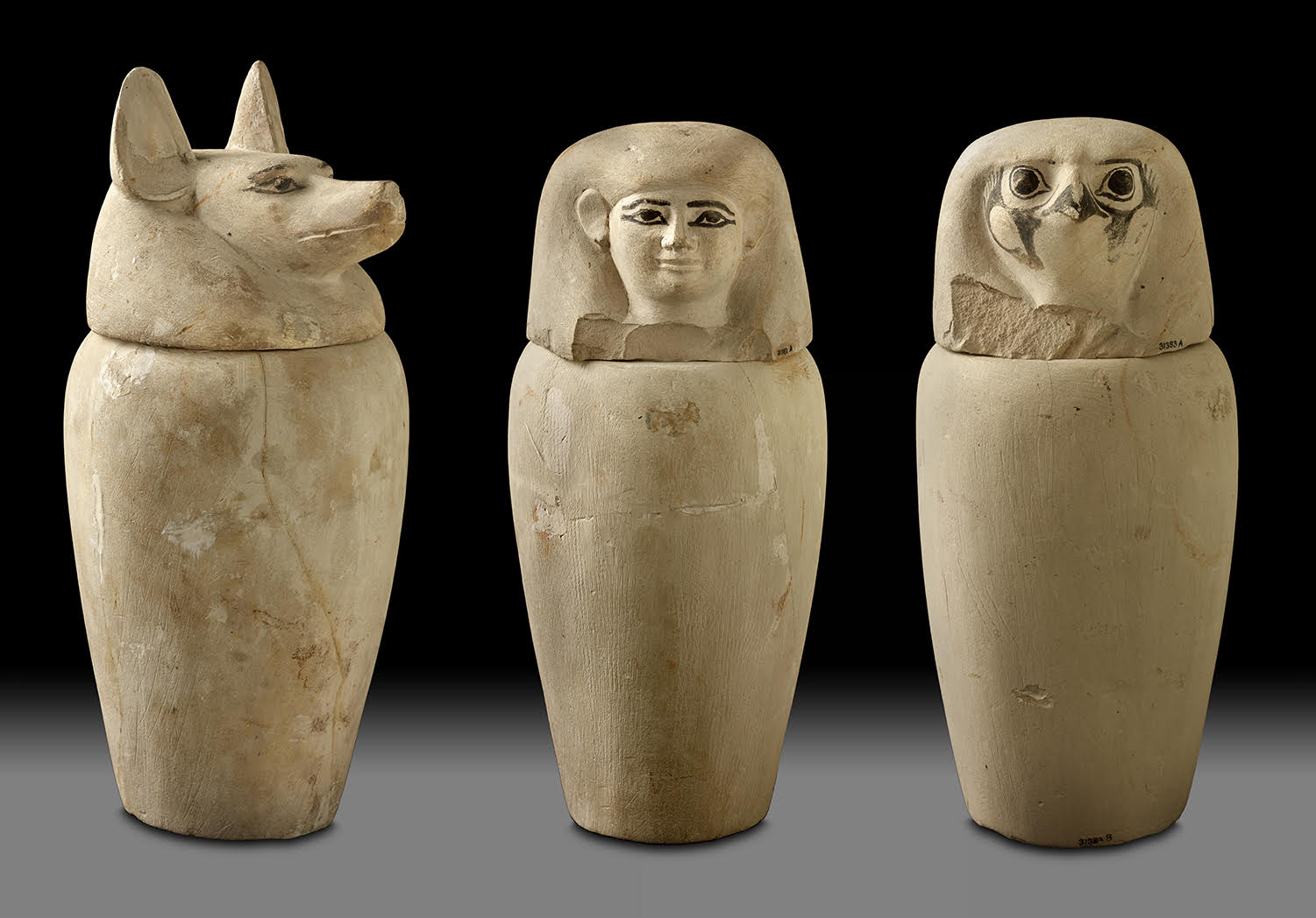 Three stone canopic jars with figural head