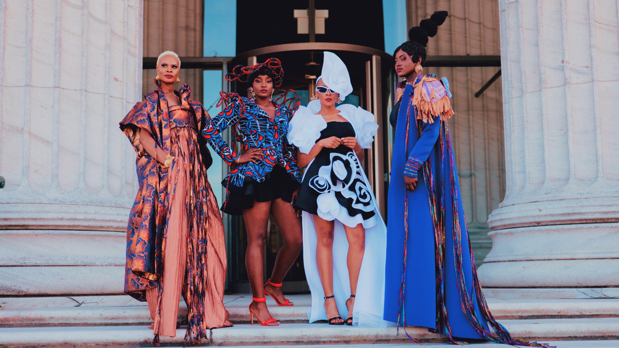 Four models wearing designer clothing