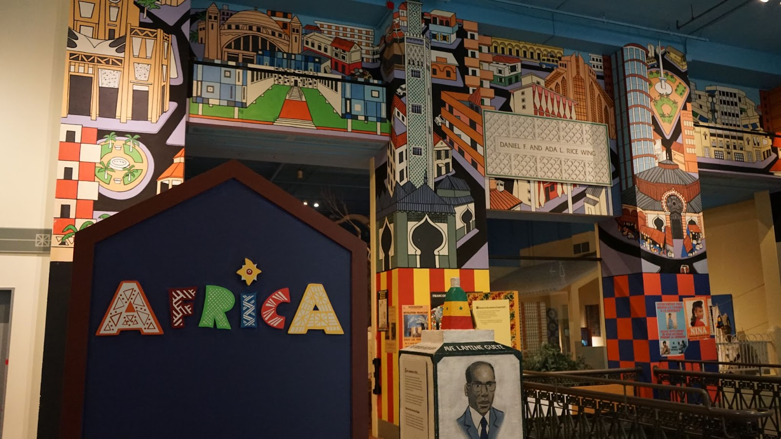 The entrance to a museum exhibition about Africa, featuring colorful murals painted on the walls.